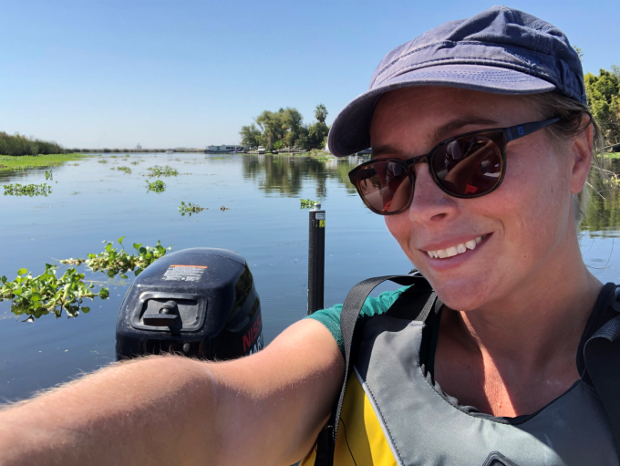 Researcher on boat in Delta waterway