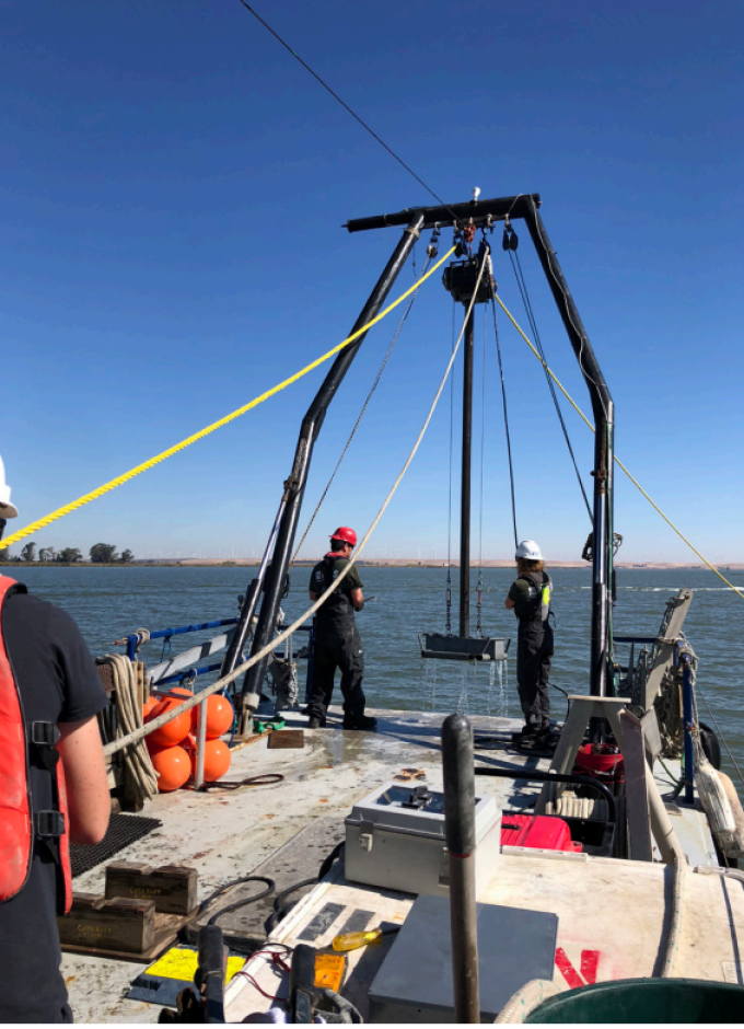 USGS marine technicians Jenny White and Pete Dal Ferro, with the help of SDSU professor Dr. Jillian Maloney, recover the vibracore on board the Retriever, while collecting sediment cores in the Sacramento River. Shannon Klotsko. 