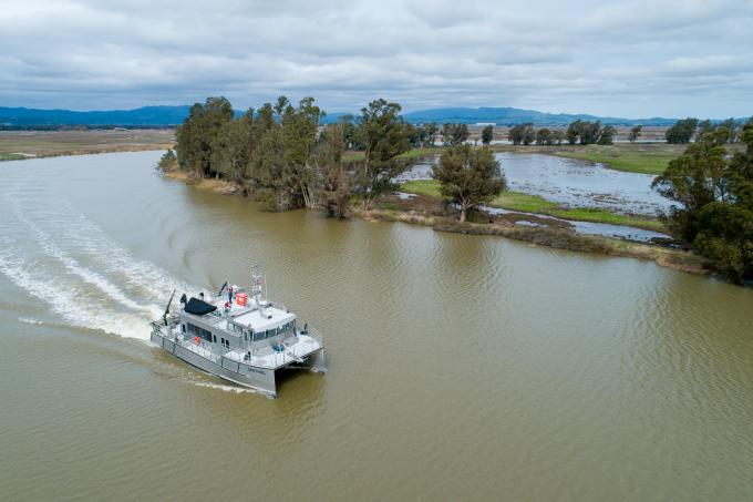 The research vessel R/V Sentinel moving through the waters of the Sacramento - San Joaquin River Delta. 